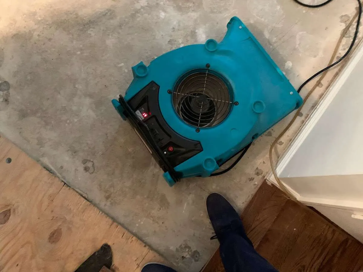 Air mover drying subfloor during Leak Detection & Repair in Baxter Village